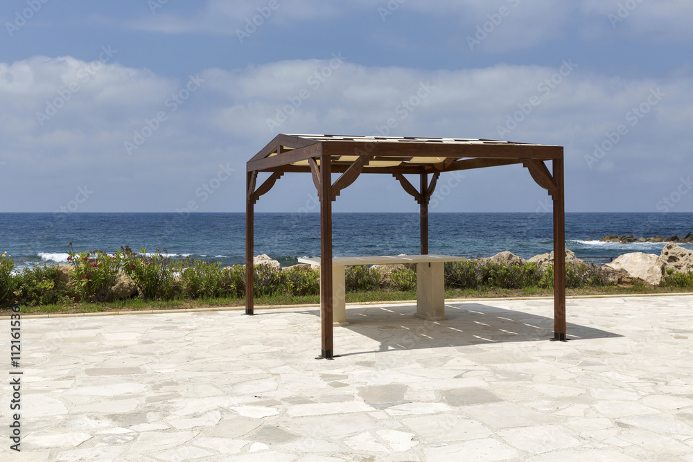 Empty pavilion on rocky sea beach