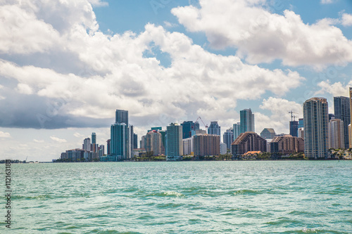 Miami Florida skyline across bay on a sunny day with clouds overhead