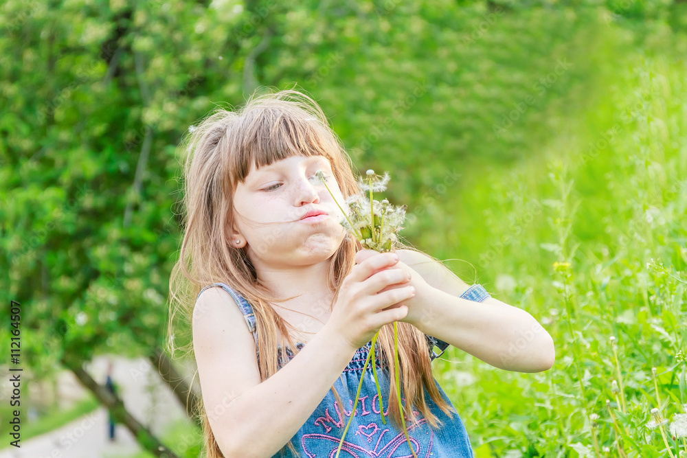 Beautiful child girl with dandelion flower in spring park. Happy Beautiful child girl with dandelion flower in spring park. Happy