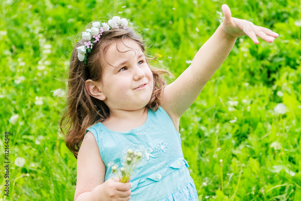 Beautiful child girl with dandelion flower in spring park. Happy Beautiful child girl with dandelion flower in spring park. Happy