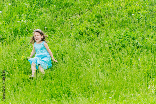 Beautiful child girl with dandelion flower in spring park. Happy
