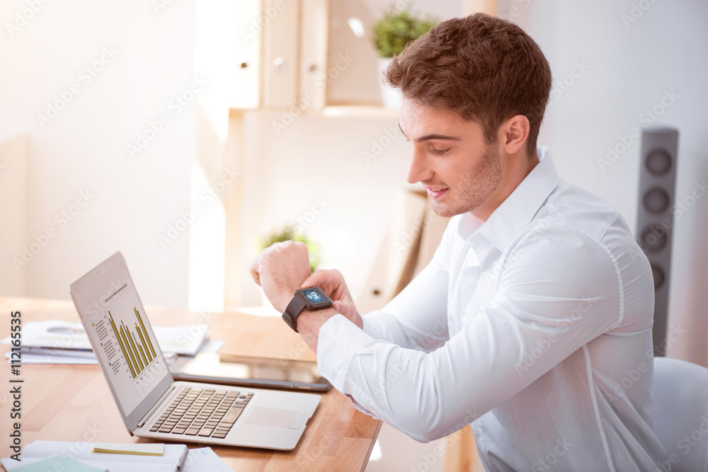 Positive man sitting at the table. 