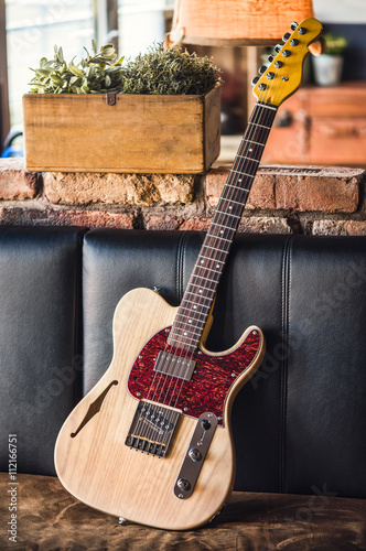 Electric Guitar Leaning Against a Couch