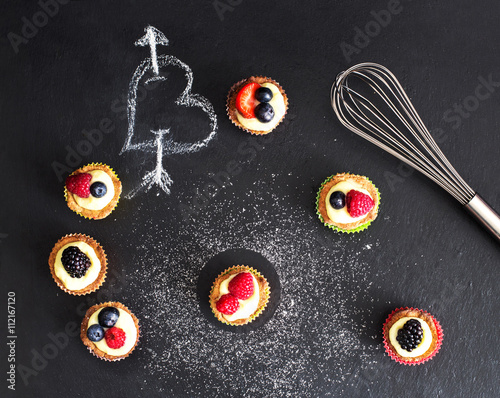 creative set of mini pastry with custard cream and red fruits