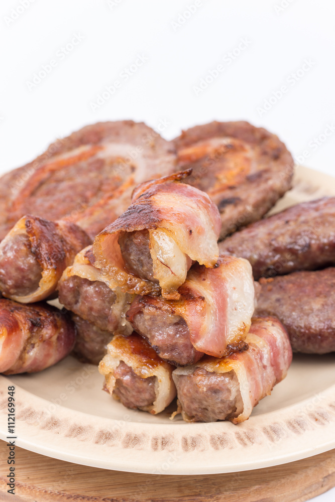 Served grilled meat on the plate over white background Served grilled meat on the plate over white background