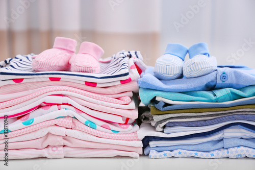 Baby clothes for newborn on white table photo