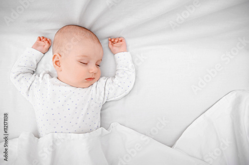 Beautiful sleeping baby in bed