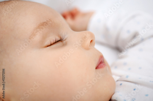 Beautiful sleeping baby in bed
