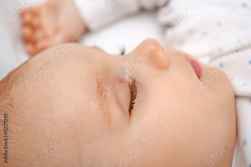 Beautiful sleeping baby in bed