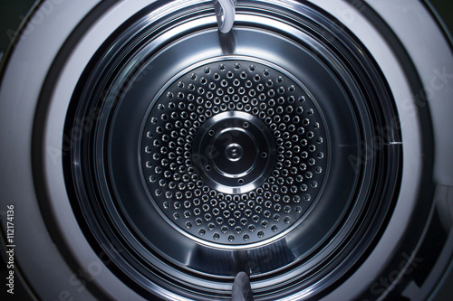 Looking inside a metal clothes dryer showing the concentric circles.