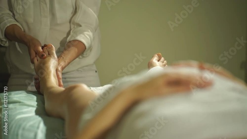 pregnant woman doing a foot massage