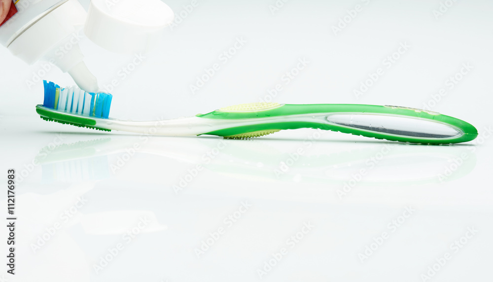 putting tooth paste on brush putting tooth paste on brush