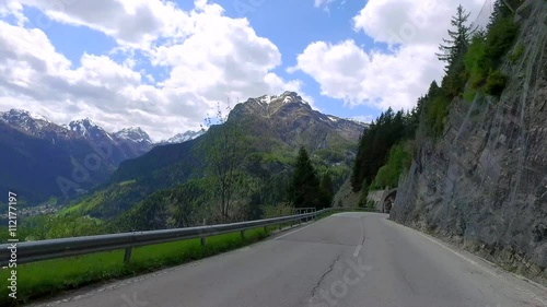 Driving a car through the winding road to Caprile in the dolomites, Italy photo