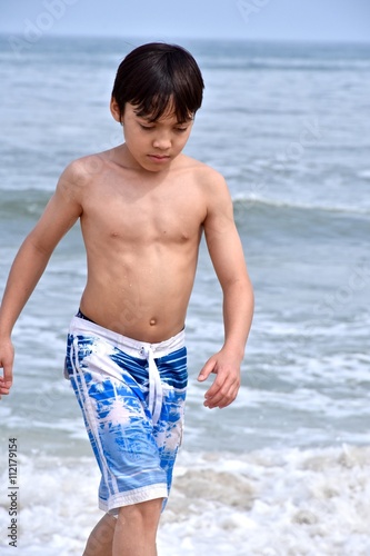 Boy playing on the ocean beach