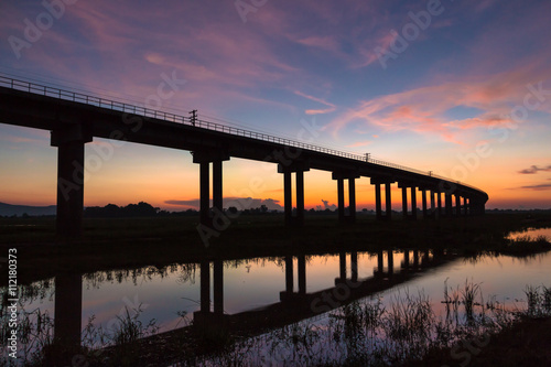 Wallpaper Mural A train is crossing bridge at  Pa Sak Jolasid Dam, Thailand in sunset time Torontodigital.ca