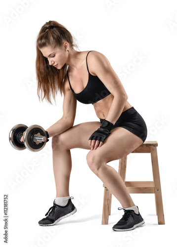 Cutout portrait of muscular young girl sitting on a chair and doing exercises.