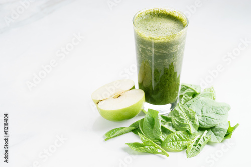 glass of fresh green spinach and kale healthy smoothie