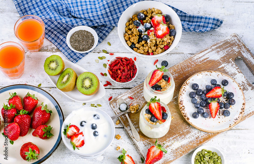 Healthy breakfast with muesli, yogurt, juice, fruits and berries
