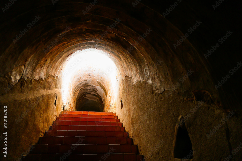 tunnel background and business concept. tunnel with old brick. the end of tunnel and concept business successfully. mystery tunnel or mystery way. tunnel damaged and waited for repair.