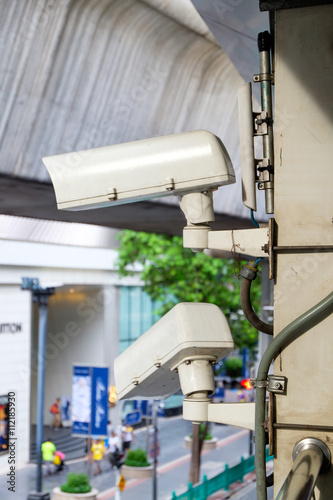 Photography Close up CCTV security camera with blur of traffic jam in the background