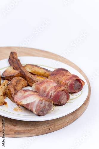 Kebabs rolled in bacon served on a plate