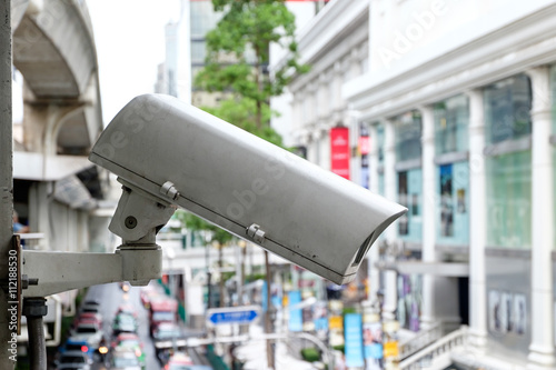Close up CCTV security camera with blur of traffic jam in the ba