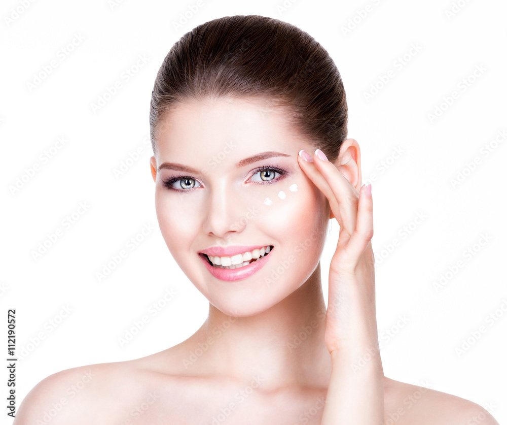 Woman with healthy face applying cosmetic cream. Woman with healthy face applying cosmetic cream.