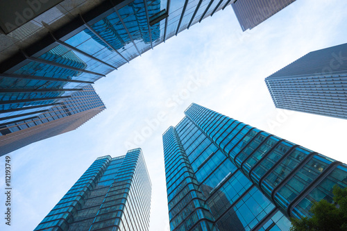 up view of modern office building in cloud sky