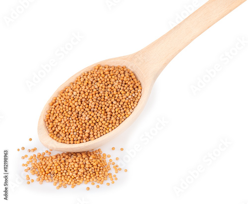 Mustard in wooden spoon isolated on white background