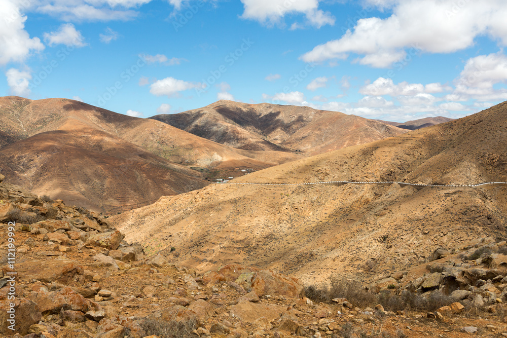 Beautiful volcanic mountains and the road on a mountain slope.  Road from la Pared to Betancuria . Fuerteventura. Canary Islands