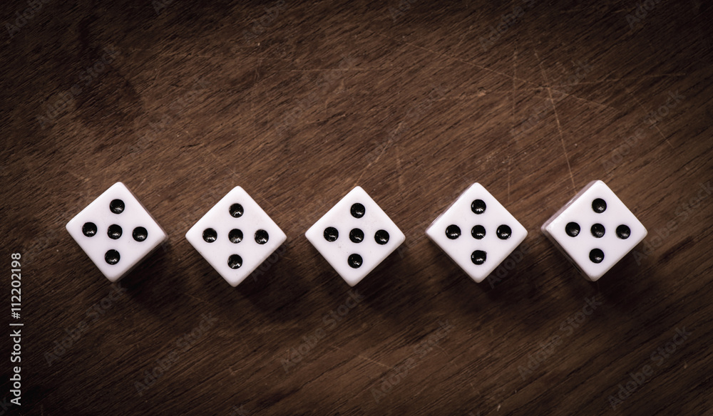 Number five dice on wooden table Number five dice on wooden table