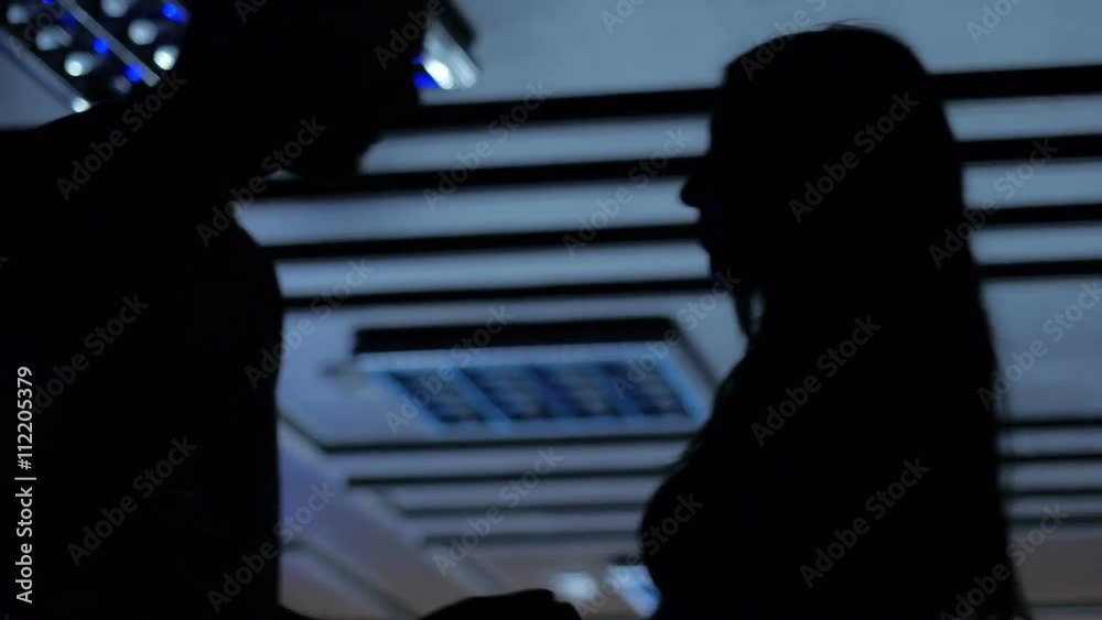 Salsa dance silhouettes spinning in spot lights lumiere dancefloor slow motion
