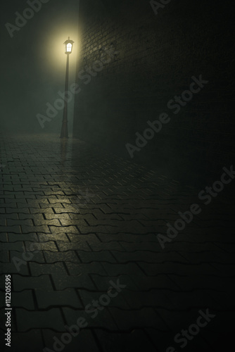 Dark alley with lamppost