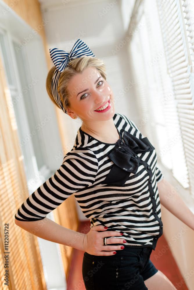 pinup young woman having fun on the balcony 