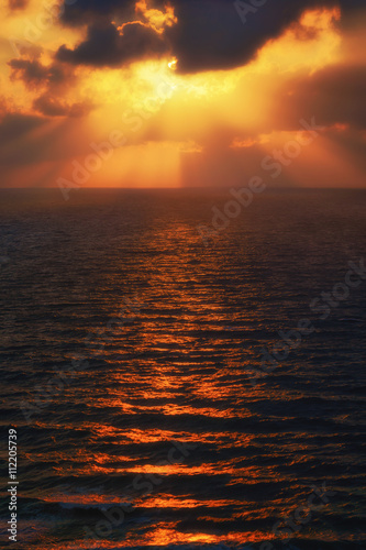 golden sun rays on the sea at sunset