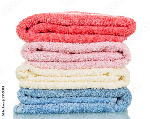 Four of terry towels different colors isolated on white.