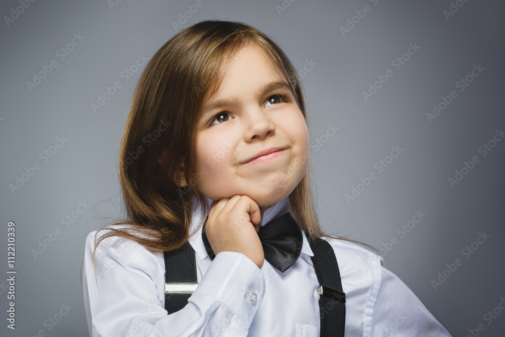 Closeup dreaming Young girl Looking Up Against Gray Background Closeup dreaming Young girl Looking Up Against Gray Background