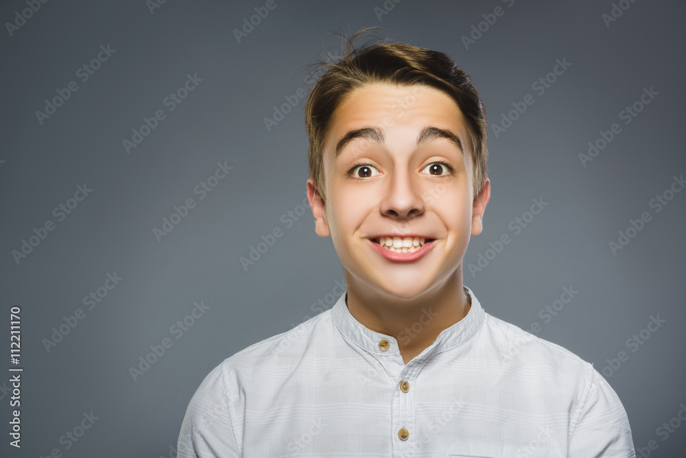 Closeup portrait successful happy boy isolated grey background. Positive human emotion face expression. Life perception achievement vision Closeup portrait successful happy boy isolated grey background. Positive human emotion face expression. Life perception achievement vision
