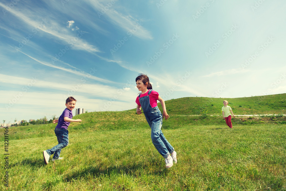 group of happy kids running outdoors
