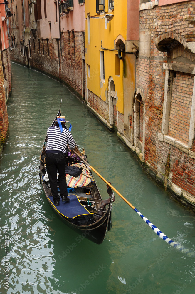 A gondola in Venice with a group of tourists.