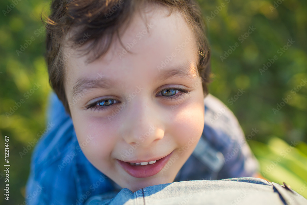 Portrait of a cute little boy in a blue shirt (tilt view)