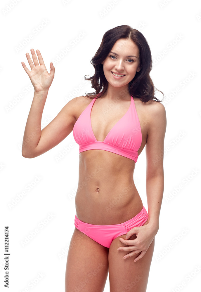 happy young woman in pink swimsuit waving hand happy young woman in pink swimsuit waving hand