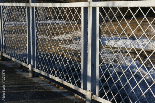 Fence of metal mesh.
