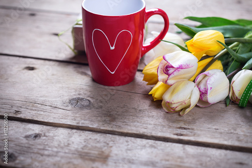 Fototapeta Naklejka Na Ścianę i Meble -  Bright yellow and white spring tulips  and cup of coffee on vint