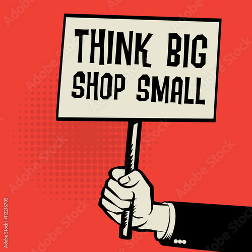 Poster in hand, business concept with text Think Big, Shop Small