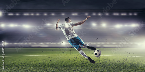 Soccer player hitting ball