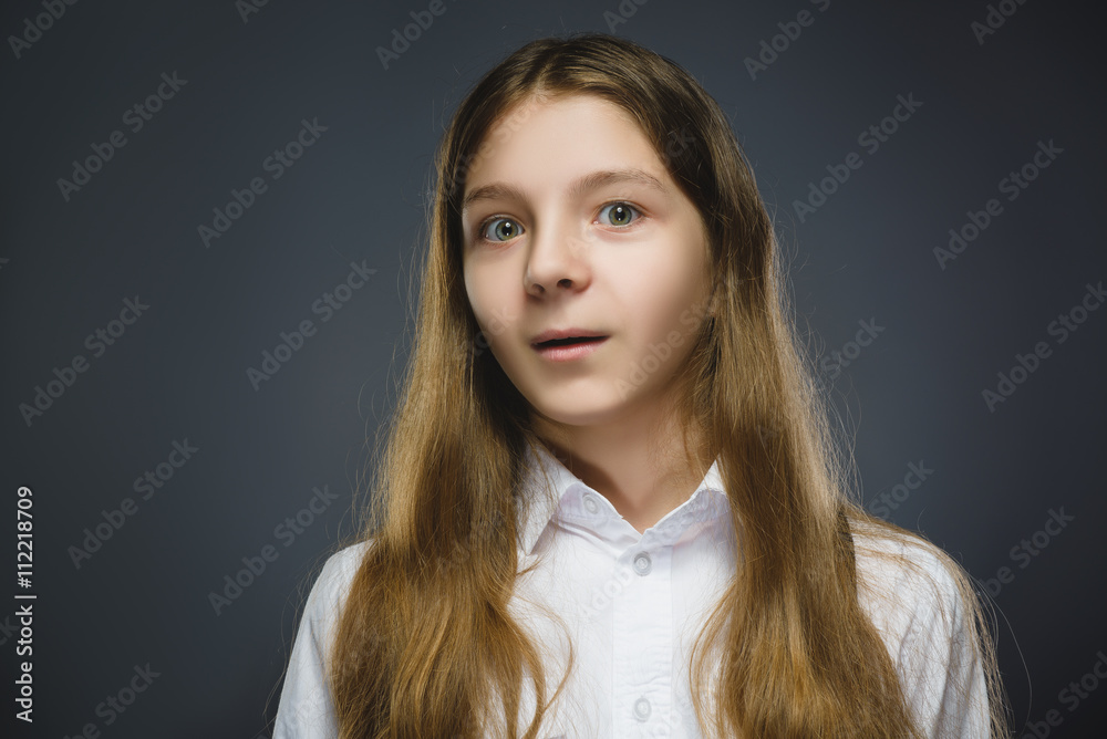 Closeup Portrait of happy girl going surprise isolated on gray background