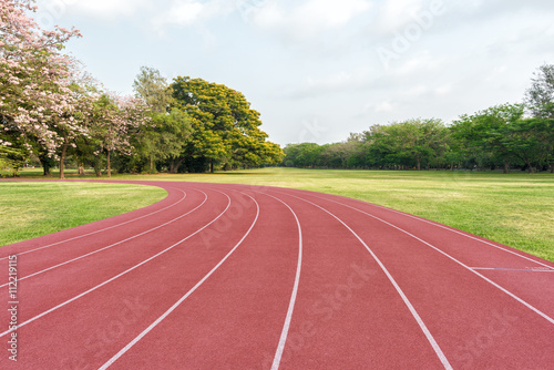 Athlete track or running track on green lawn in the park