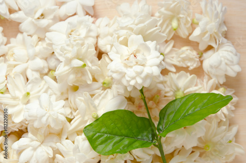 Jasmine flowers grouped on wooden board background