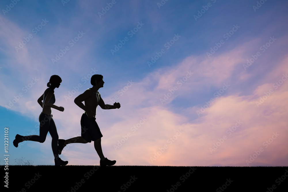 silhouette man and woman running with sunset sky   background